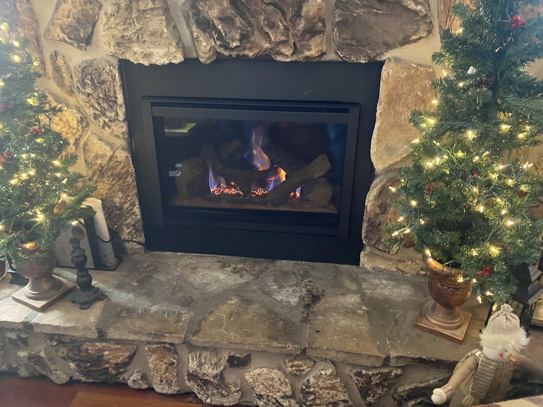 Glowing fireplace with a rustic stone surround